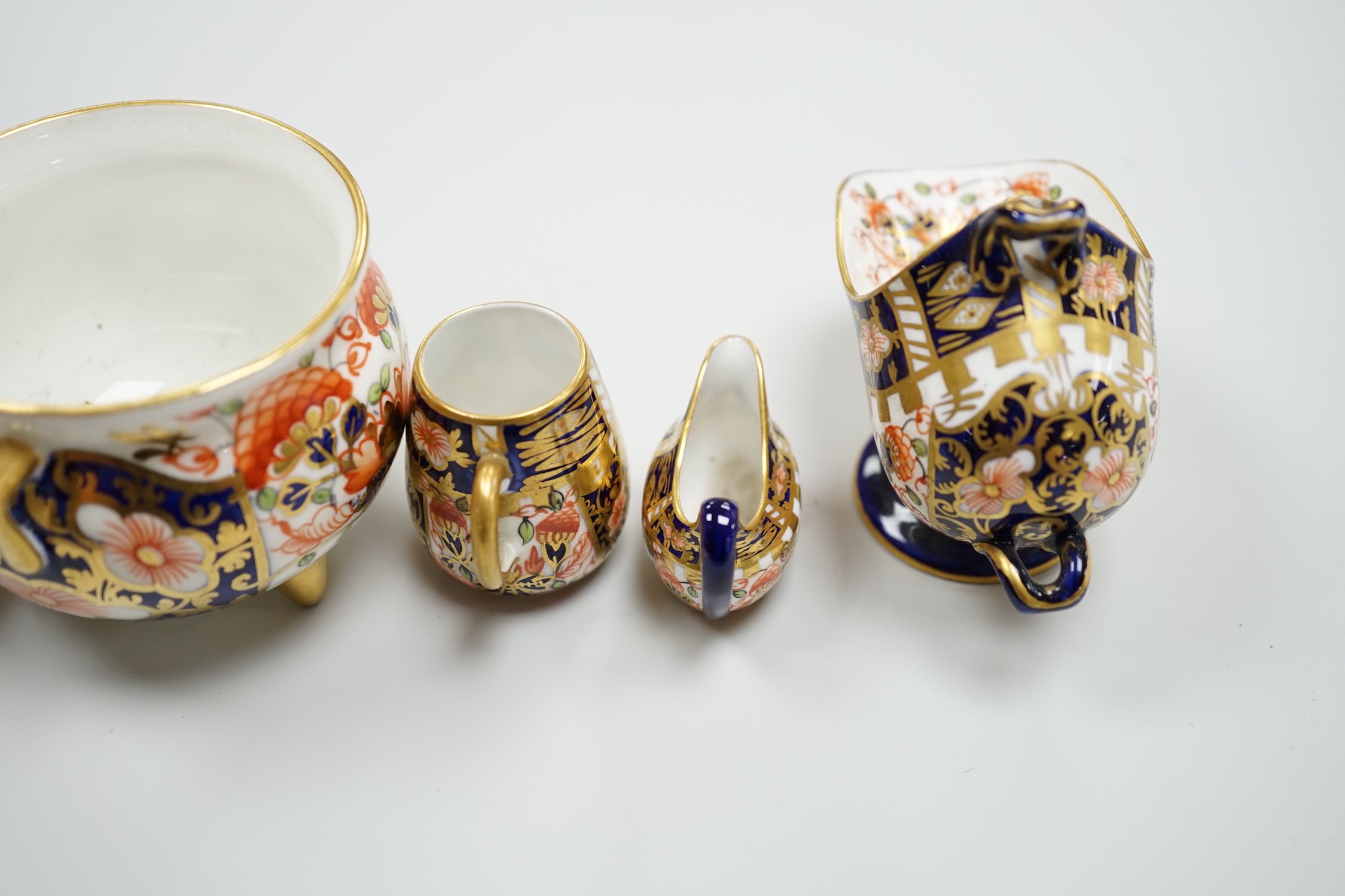 20th century Derby miniature wares in Imari patterns including a mug, a sauceboat, a cauldron, a large cauldron and a spoon warmer